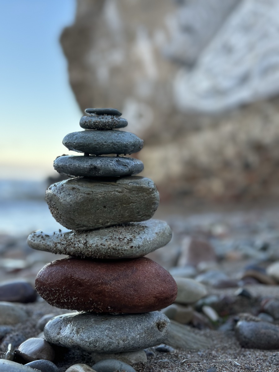 A balanced stack of stones on a beach
